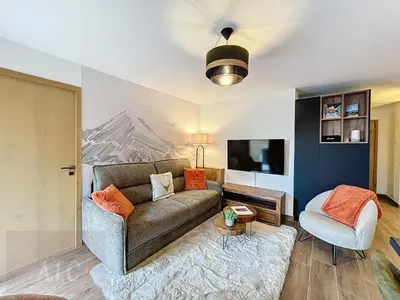 a living room with a couch and a chair at Appartement d'Exception 2 Chambres, 63 m², au Pied des Pistes, Parking Inclus, Wi-Fi - FR-1-560-142 in Combloux