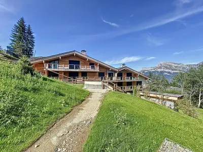 a house on a hill with a dirt road at Appartement d'Exception 2 Chambres, 63 m², au Pied des Pistes, Parking Inclus, Wi-Fi - FR-1-560-142 in Combloux