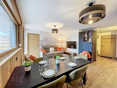 a dining room and living room with a table and chairs at Appartement d'Exception 2 Chambres, 63 m², au Pied des Pistes, Parking Inclus, Wi-Fi - FR-1-560-142 in Combloux