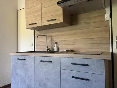 a kitchen with wooden cabinets and a counter top at Mont Lachat - Central - Vues magnifiques in Saint-Gervais-les-Bains