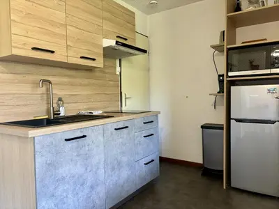 a kitchen with a sink and a refrigerator at Mont Lachat - Central - Vues magnifiques in Saint-Gervais-les-Bains