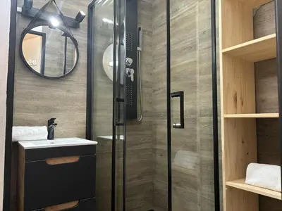 a bathroom with a shower with a sink and a mirror at Mont Lachat - Central - Vues magnifiques in Saint-Gervais-les-Bains