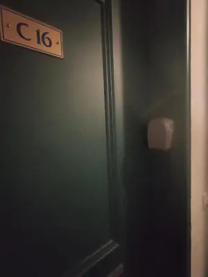 a bathroom with a green door with a sign on it at charmant appartement 2-4 personnes coeur de chamonix in Chamonix-Mont-Blanc