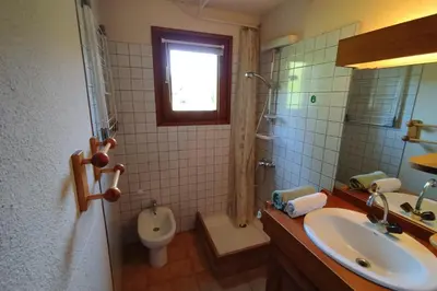 a bathroom with a sink and a toilet and a window at Beautiful apartment near the slopes of Megève in Megève
