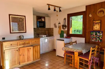 a kitchen with a table and a small kitchen with a table and chairs at Beautiful apartment near the slopes of Megève in Megève