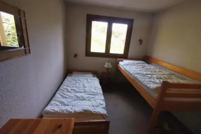 a room with two beds and a window at Beautiful apartment near the slopes of Megève in Megève