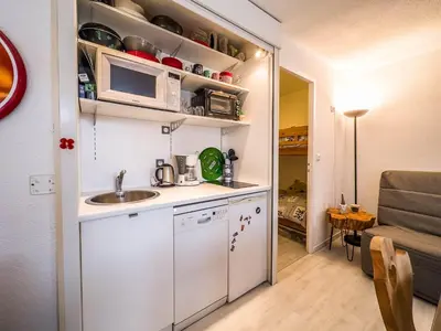 a small kitchen with a sink and a microwave at Appartement en pied de piste dans résidence en haute Savoie in Morillon