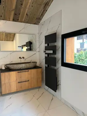 a bathroom with a sink and a window at Appartement cosy rénové in Megève