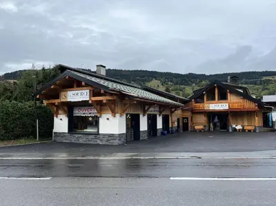 a store front of a wooden building on a street at Appartement cosy rénové in Megève