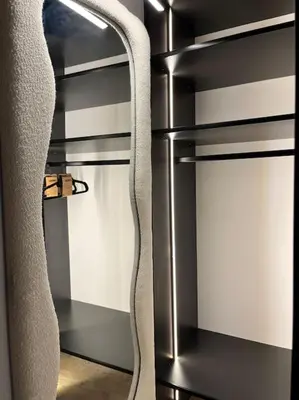 a black refrigerator with a ladder in a room at Appartement cosy rénové in Megève