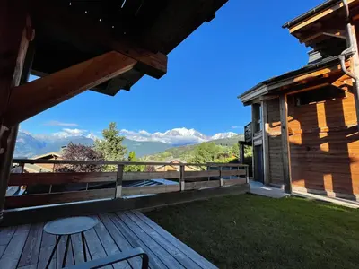 a deck with a view of the mountains at Appartement Luxe comme un Chalet - vue exceptionnelle in Combloux
