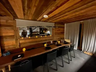 a dining room with a large wooden table and chairs at Appartement Luxe comme un Chalet - vue exceptionnelle in Combloux