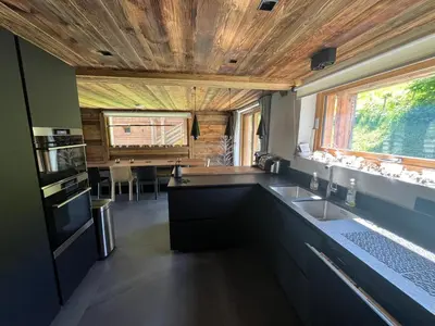 a kitchen with a sink and a counter at Appartement Luxe comme un Chalet - vue exceptionnelle in Combloux
