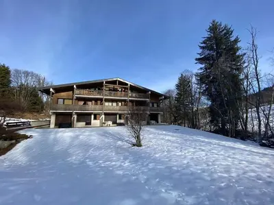 a house with snow in front of it at Appartement Calme et Chaleureux in Demi-Quartier
