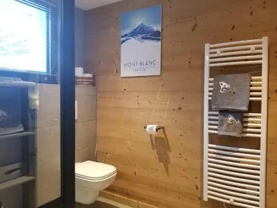 a bathroom with a toilet and a sign on the wall at Chalet Walser à VALLORCINE 13 kms CHAMONIX France in Vallorcine