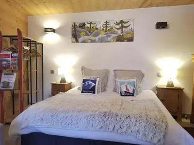 a bedroom with a white bed with two lamps at Chalet Walser à VALLORCINE 13 kms CHAMONIX France in Vallorcine
