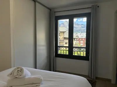 a bedroom with a bed and a window with a view at Le Bettex - Lumineux - Vue montagne in Saint-Gervais-les-Bains