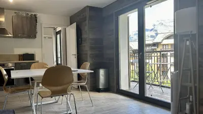 a kitchen and dining room with a table and chairs at Le Bettex - Lumineux - Vue montagne in Saint-Gervais-les-Bains