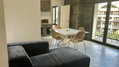 a living room with a table and chairs and a kitchen at Le Bettex - Lumineux - Vue montagne in Saint-Gervais-les-Bains