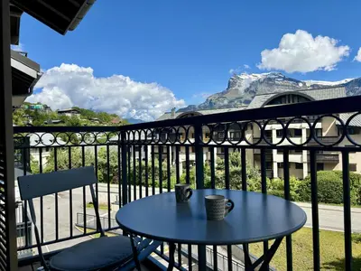 a table and chairs on a balcony with a mountain at Le Bettex - Lumineux - Vue montagne in Saint-Gervais-les-Bains