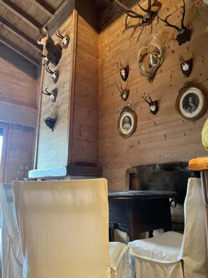 a room with chairs and antlers on the wall at Appartement de standing Mont d'Arbois in Megève
