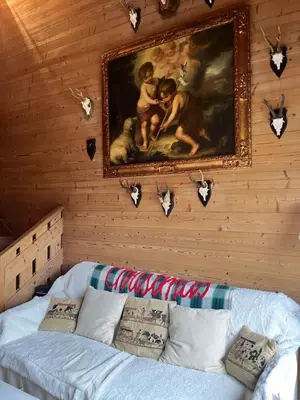 a wall with a painting and a couch in a room at Appartement de standing Mont d'Arbois in Megève