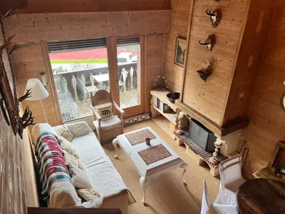 a living room with a couch and a fireplace at Appartement de standing Mont d'Arbois in Megève