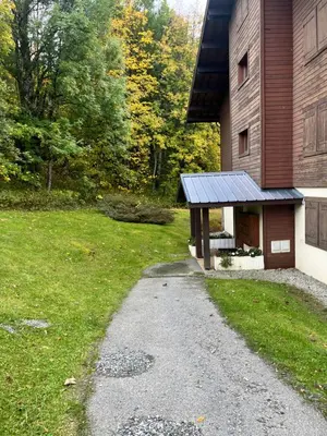 a house with a gravel path next to a building at Appartement de standing Mont d'Arbois in Megève