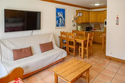 a living room with a white couch and a table at Le Névé in Saint-Gervais-les-Bains