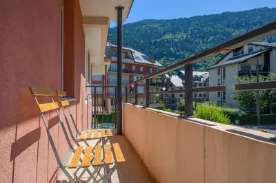 a balcony with a bench on the side of a building at Le Névé in Saint-Gervais-les-Bains