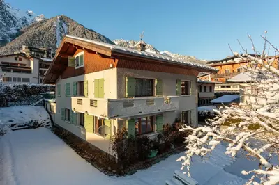two beds in a room with a window at Residence Edelweiss - Chamonix All Year in Chamonix-Mont-Blanc