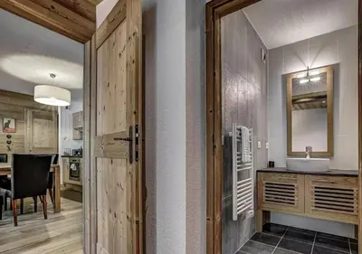 a bathroom with a sink and a mirror at Charming Apartment Chamonix Valley in Vallorcine