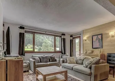 a living room with a couch and a table at Charming Apartment Chamonix Valley in Vallorcine