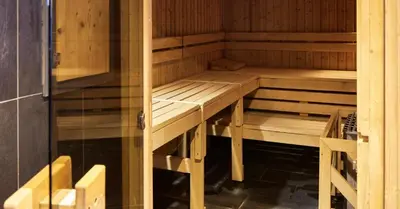 a wooden sauna with wooden benches in a room at Charming Apartment Chamonix Valley in Vallorcine