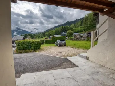 a car parked in the driveway of a house at Appartement 6p à Samoëns avec parking, proche télécabine - FR-1-642-90 in Samoëns