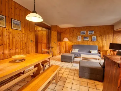 a living room with a table and a couch at Appartement 6p à Samoëns avec parking, proche télécabine - FR-1-642-90 in Samoëns
