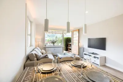 a living room with a couch and a tv at Flat La Loge - At the foot of the Jaillet in Megève in Megève
