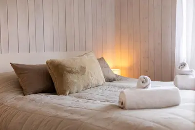 a bed with two stuffed animals sitting on top of it at Flat La Loge - At the foot of the Jaillet in Megève in Megève