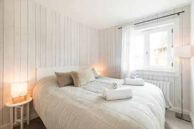 a bedroom with a large bed with two towels on it at Flat La Loge - At the foot of the Jaillet in Megève in Megève