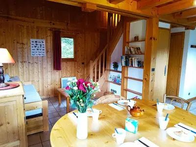 a wooden room with a table with flowers on it at Le Mazot des Tacounets in Saint-Gervais-les-Bains