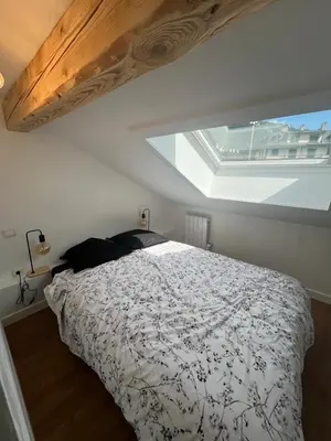 a bedroom with a bed with a large window at Residence VARLOPE in Chamonix-Mont-Blanc