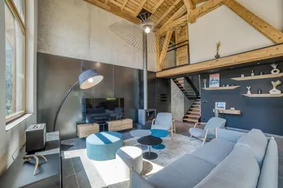a living room with a blue couch and chairs at Chalet mitoyen - Jacuzzi - Cousinade I in Les Contamines-Montjoie