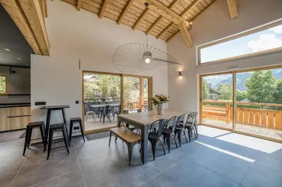 a kitchen and dining room with a table and chairs at Chalet mitoyen - Jacuzzi - Cousinade I in Les Contamines-Montjoie