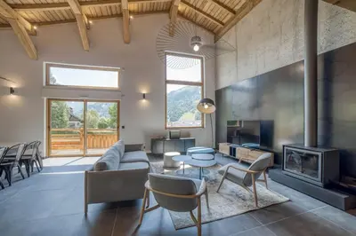 a living room with a couch and a table at Chalet mitoyen - Jacuzzi - Cousinade I in Les Contamines-Montjoie