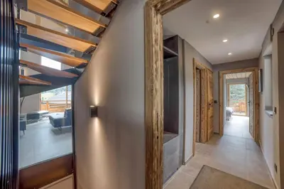 a hallway of a house with a mirror on the wall at Magnifique chalet mitoyen - Jacuzzi - Cousinade II in Les Contamines-Montjoie