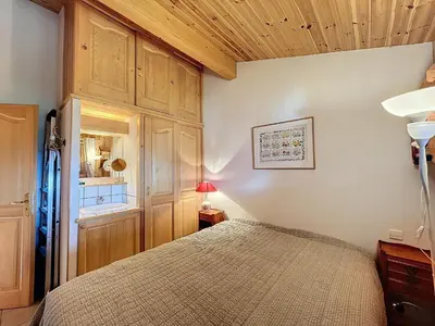 a bedroom with a bed and a wooden ceiling at Appartement 3 pièces tout équipé avec balcon et box fermé, à 1,2 km du centre de Combloux - FR-1-560-141 in Combloux