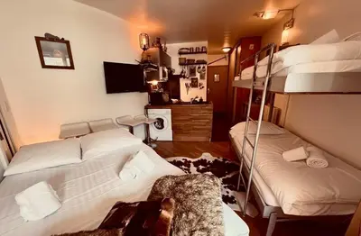 a room with two bunk beds in a room at CHAMONIX Centre - Studio de charme avec parking, Vue sur le Mont-Blc in Chamonix-Mont-Blanc