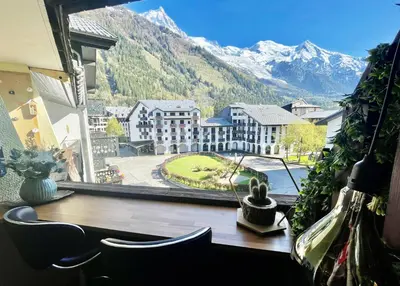 a room with a window with a view of a mountain at CHAMONIX Centre - Studio de charme avec parking, Vue sur le Mont-Blc in Chamonix-Mont-Blanc