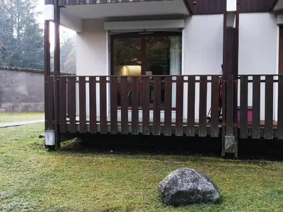 a porch of a house with a rock in the yard at Chamonix, studio de 24 m2 in Chamonix-Mont-Blanc