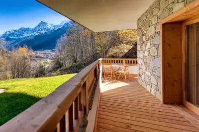 a wooden balcony with a view of the mountains at MGM Charles Delys - 3 Rooms - Les Houches in Les Houches